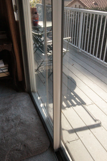 Installed Draft Stopper weatherstripping Increases Protection from Winds and Drafts for Sliding Glass Doors and Windows